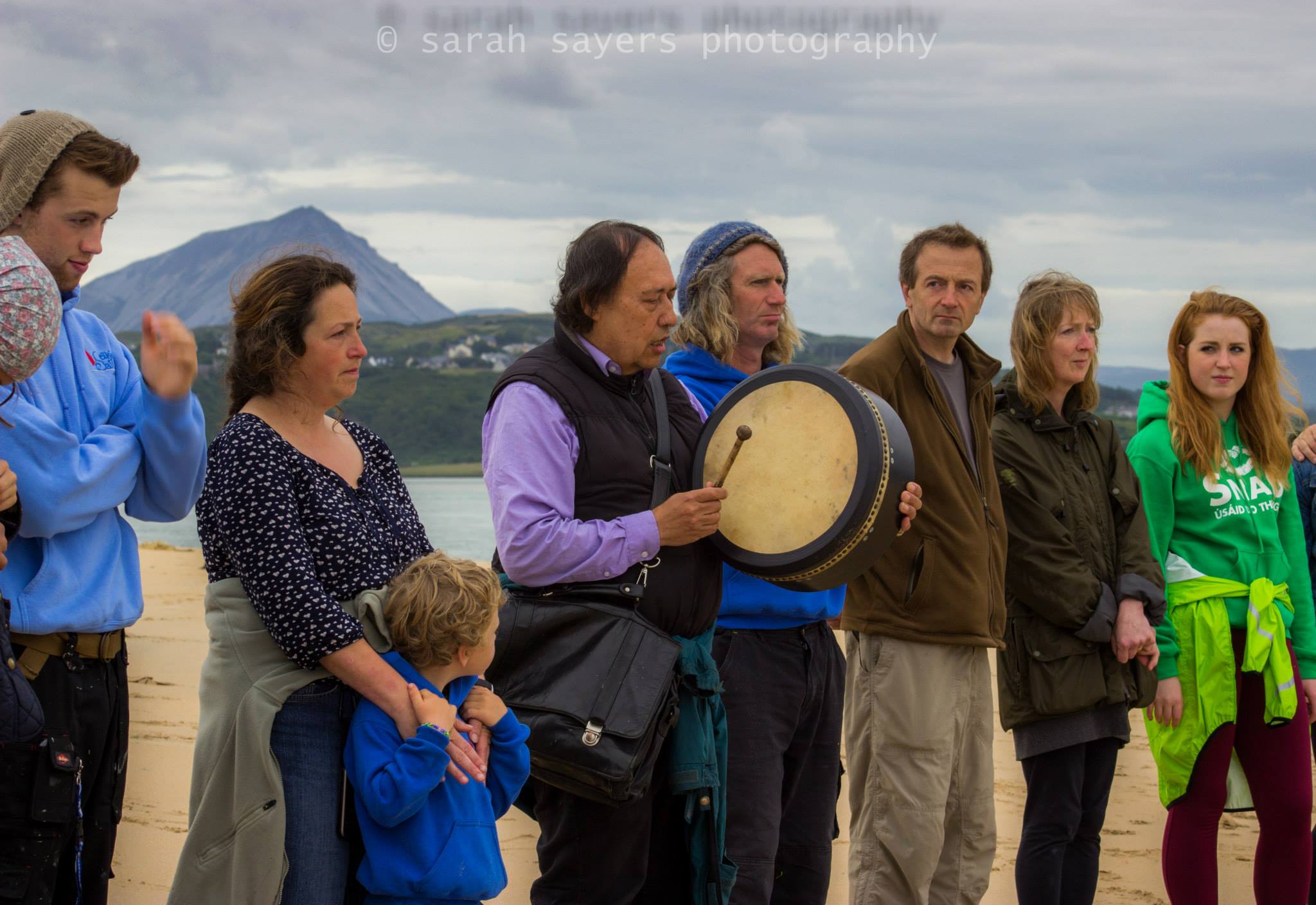 Local people gather with Native American Indian Gary (White Deer) for special prayers and a blessing of family of whales that died at Ballyness beach, Falcarragh, Donegal (photo courtesy of Sarah Sayers).